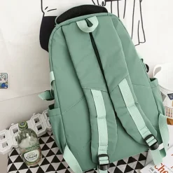 Pink Waterproof School Bags Nylon Backpack with Plush Monkey Keychain - Stylish and Durable School Bag with Multiple Pockets for Travel and Everyday Use